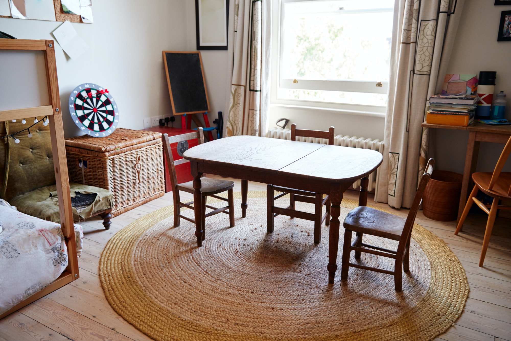 Empty Interior Of Young Boys Bedroom With Table And Storage